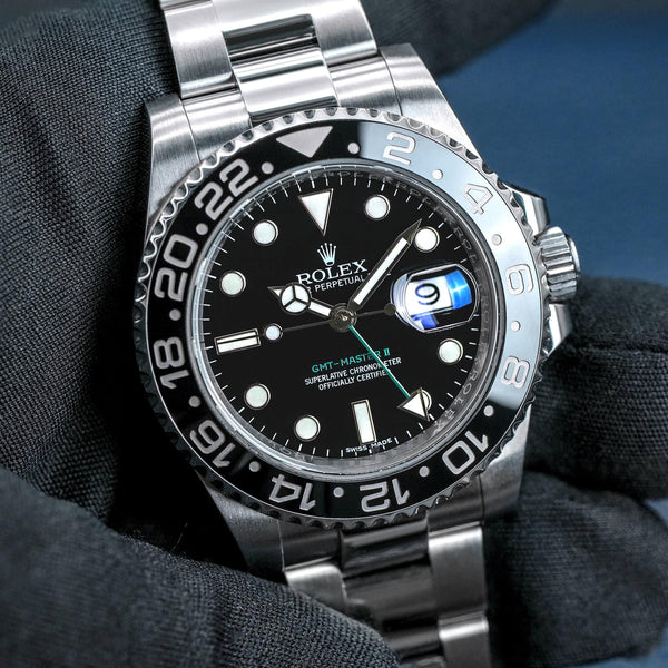 Front view of Rolex GMT-Master II 116710LN Green Arrow in gloved hand