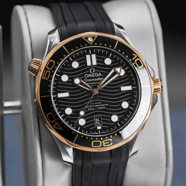 Close-up angled view of Omega Seamaster Diver 300M Black Dial Sedna Gold