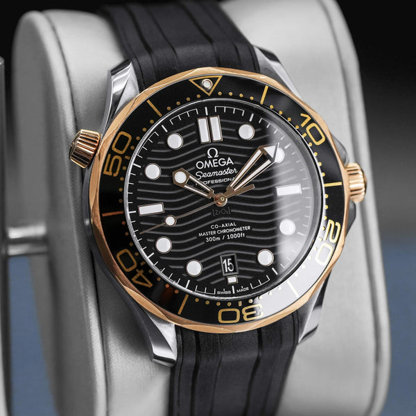 Angled view with reflection of Omega Seamaster Diver 300M Black Dial Sedna Gold
