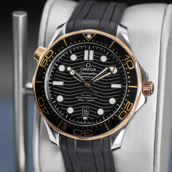 Slight angled view showing crown on Omega Seamaster Diver 300M Black Dial Sedna Gold
