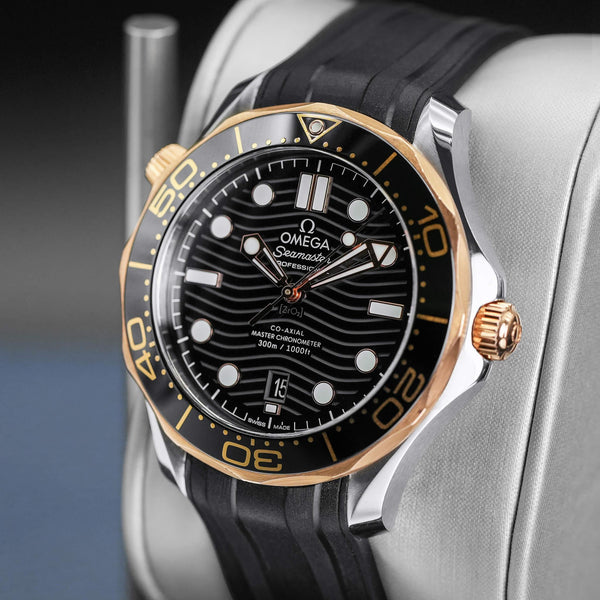 Angled opposing view with reflection of Omega Seamaster Diver 300M Black Dial Sedna Gold
