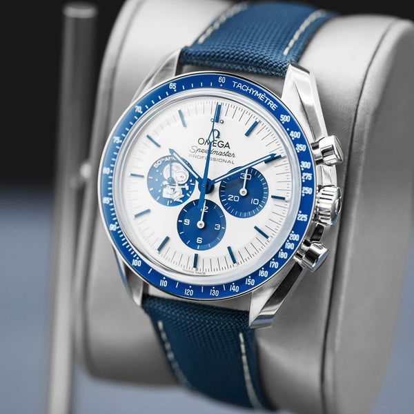 Angled opposing view with reflection of Omega Speedmaster “Silver Snoopy Award” 50th Anniversary 2022