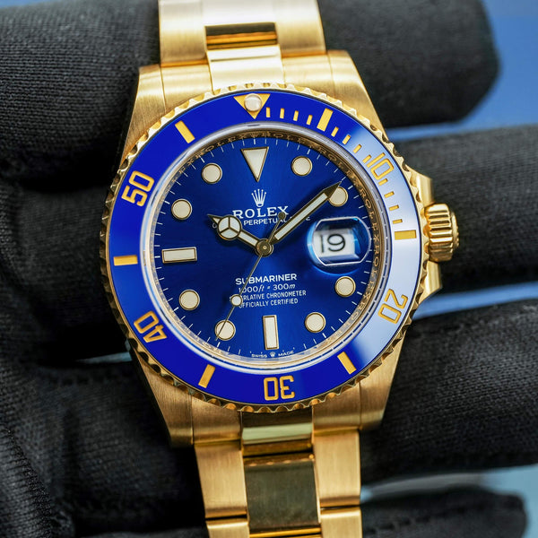 Front view of Rolex Submariner "Bluesy" 126618LB Yellow Gold in gloved hand