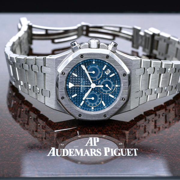 Audemars Piguet Royal Oak Chronograph with blue dial and integrated bracelet, positioned on branded surface