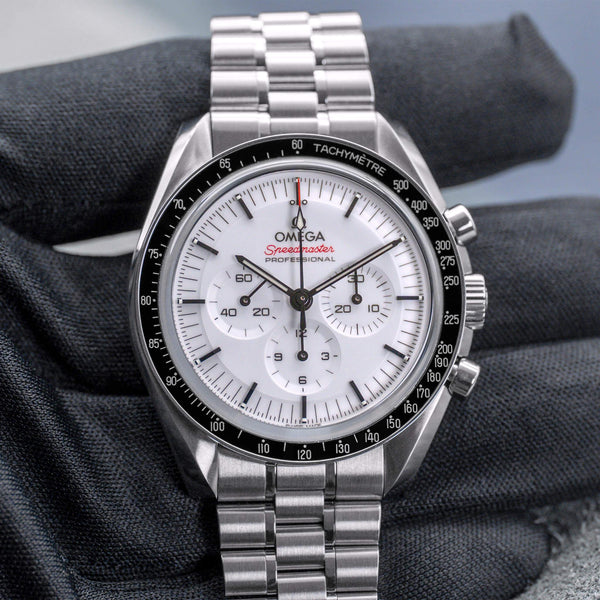 Front view of Omega Speedmaster Professional Moonwatch "Sapphire Sandwich" 2026 in gloved hand