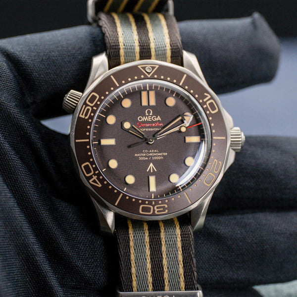 Front view of Omega Seamaster Diver 300M No Time To Die 007 Edition in gloved hand