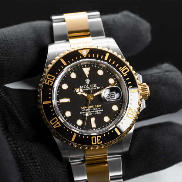 Front view of Rolex Sea-Dweller Two Tone 126603 in gloved hand