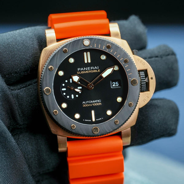 Front view of Panerai Submersible QuarantaQuattro Goldtech Orocarbo PAM02070 in gloved hand