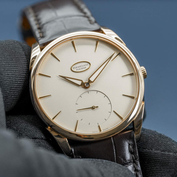 Front view of Parmigiani Fleurier Tonda 1950 Rose Gold White Dial in gloved hand