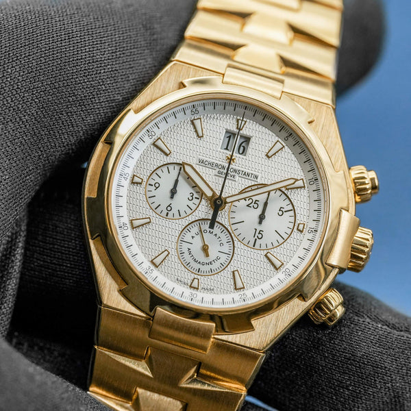 Front view of Vacheron Constantin Overseas 49150 Yellow Gold White Dial in gloved hand
