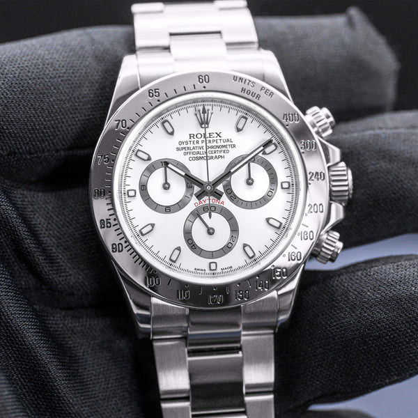 Front view of Rolex Cosmograph Daytona 116520 White Dial in gloved hand