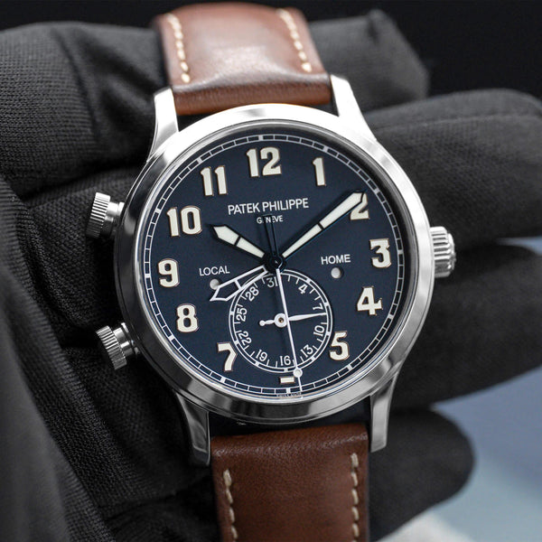 Front view of Patek Philippe Calatrava Travel Time 5524G Blue Dial in gloved hand